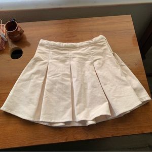 Brand new mini pleated skirt cream color.